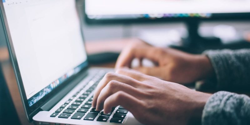 photo of person typing on laptop